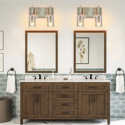 Bathroom with brushed nickel vanity light fixture with clear glass and metal mesh 2 light vanity lights above mirrors.