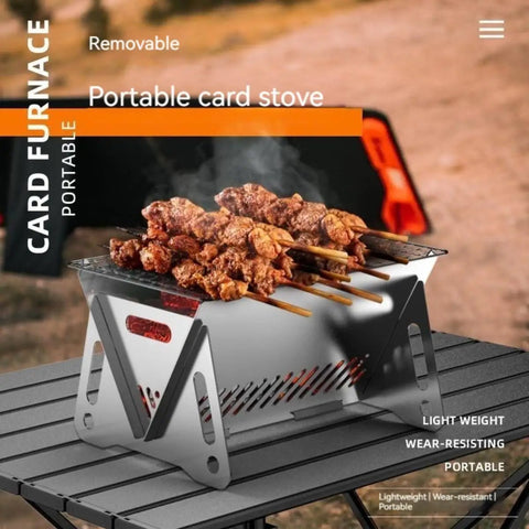Portable Foldable BBQ Grill With Carry Bag For One To Two People On The Go Mini Charcoal Grill with skewers on a table.