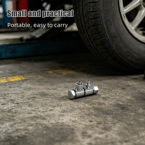 Air Valve Connector For Tire Changers, Steel Quick Release With 9.7mm Thread And 8mm Output, Leakproof Performance, Heavy Duty Tire Tool For Auto Shops And Pneumatic Tire Removal And Maintenance on workshop floor beside tire