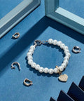 8Pcs 18K Gold Plated Necklace Shortener Clasp Brass Enhancer Set With Cubic Zirconia Sparkly Dope Mini Push Clasp Connectors displayed with pearl bracelet