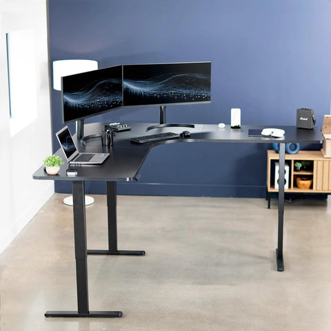 Rock Solid Corner Standing Desk Rig In Matte Black With Lightning Fast Height Adjustments And Split Tabletop Design showcasing dual monitors and laptop.