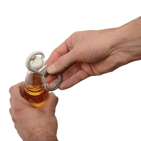 Person using Dual Bottle Opener And SBiner Carabiner Combo In Stainless Steel with double sided openers to open a bottle.