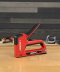 5-In-1 Manual Staple And Nail Gun For Woodworking And Craft Projects Wire Stapler And Brad Nailer In One Handy Tool on table