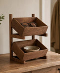 Solid Wood Two Tier Storage Shelf With Smooth Tilt Trays Warm Brown Finish Compact Floor Rack For Books And Gear Keeps Your Place Straight Up Clean And Totally Organized with glasses and bowl.
