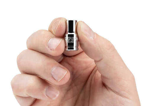 Hand holding a 1/4 Inch Drive Hex Bit Holder Socket with Magnetic Retention showing die-stamped size markings for easy reading.