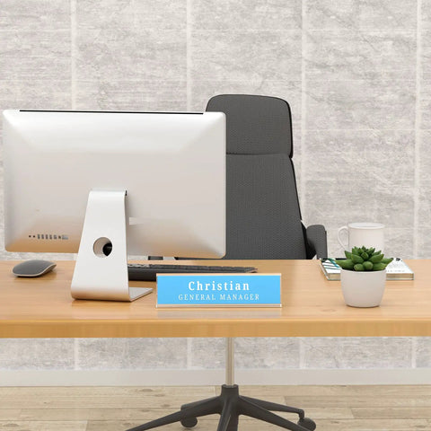 Clear Desk Name Plates Set Of 12 Personalized 2x8 Inch Sign Holders on office desk with computer and plant
