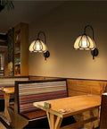 Nordic Floral Petal Wall Sconce Fabric Shade Wall Light,Warmth illuminating cozy restaurant booth with warm, soft light.