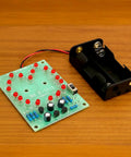 Two Sets Solder Practice Kit With Heart Shaped LED Lucky Wheel DIY Soldering Project, circuit board and battery holder on table