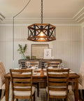 Kickass 14 Inch Black Farmhouse Pendant Light With Plug In Dimmable Switch And Adjustable Woven Cord For Kitchen Island Or Dining Room overhead above dining table with rustic oak wood and metal cage.