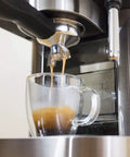 Top Tier Stainless Steel Espresso Machine With Reliable 19 Bar Italian Pump and Quick Ground Or ESE Pod Brewing Featuring Precise Temp Control and Zero Frustration Pre Brew For Killer Daily Coffee Routines brewing espresso into a clear cup.