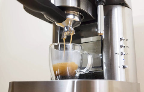 Top Tier Stainless Steel Espresso Machine With Reliable 19 Bar Italian Pump and Quick Ground Or ESE Pod Brewing Featuring Precise Temp Control and Zero Frustration Pre Brew For Killer Daily Coffee Routines brewing espresso into a clear cup.