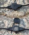 Beefy 50 Foot 14 Gauge Heavy Duty Extension Cord with Eleven Evenly Spaced Sockets, outdoor close-up on rocky surface