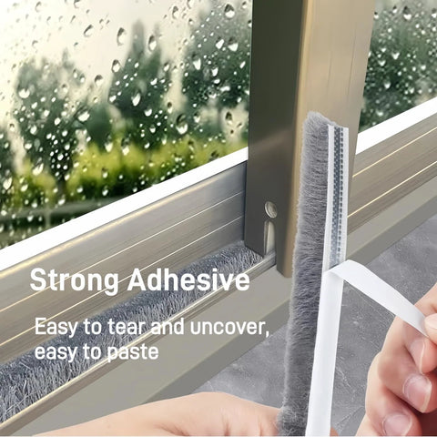 Installed gray window weather stripping with adhesive backing and brush seal on metal door frame.