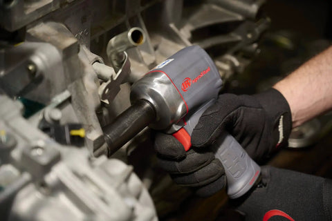 Mechanic using Half Inch Air Impact Wrench With Quiet Technology Up To 650 Foot Pounds Of Torque Ultra Compact And Light Weighs About Two Point Four Pounds Max Control for assembly