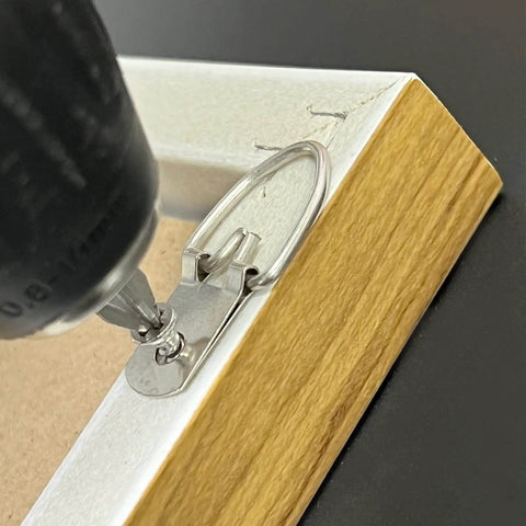 Close-up of 100 Pack D Ring Picture Hangers With Screws For Hanging Frames Mirrors Clocks Paintings Ten Pound Load Support