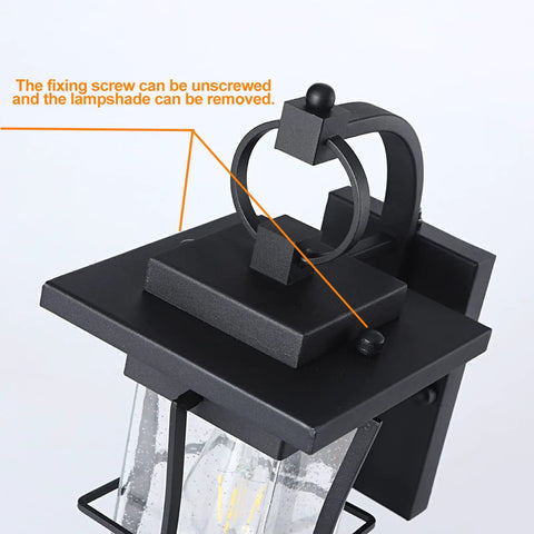 Close-up of Dusk To Dawn Outdoor Wall Lantern With Sensor, Matte Black Porch Light, showing removable lampshade and fixing screw.