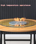 Top Shelf Heavy Duty Tempered Glass Lazy Susan Turntable on wooden table with flames, showcasing high temperature resistance.
