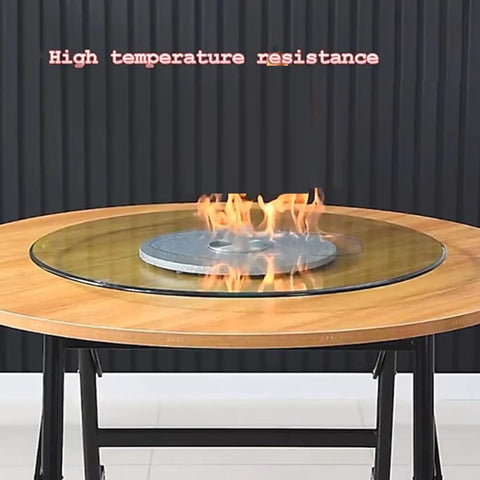 Top Shelf Heavy Duty Tempered Glass Lazy Susan Turntable on wooden table with flames, showcasing high temperature resistance.