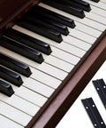 Badass Heavy Duty Piano Hinge Thirty Six Inches Long By One Point Two Inches Wide Smooth Pivoting Black Continuous Cabinet Hinge With Premium Fasteners For Custom Builds And Shop Rig Mods next to piano keys.