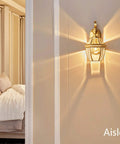 Modern Retro Copper Wall Lamp Sconce For Bedroom And Hallway Wall Mounted Light Fixture with warm ambient glow on wall.