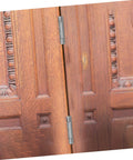 NUOBESTY pair of double swinging self-closing door hinges installed on brown wooden double doors (front view)
