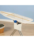 Deluxe Ironing Board Pad And Cover With Sewing Guide Pattern Cream shown on ironing board with woven pad and cord binding.
