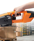 Heavy Duty Automatic Strapping Tool, Rechargeable Battery Powered Packaging Machine held in hand, securing box in warehouse.