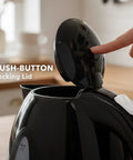 Image of a black electric kettle with push-button locking lid, showing the open top. Electric Kettle 1.7 Liter Fast Boil Water Heater For Coffee Or Tea BPA Free With Water Level Gauge Auto Shut Off Boil Dry Protection Indicator Light Removable Filter Black.