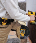 Person using Beefy Drill Belt Clip And Tape Measure Holder For Tool Belts, Universal Clip On Carry For Impact Drivers, Yellow Aluminum Steel Construction.