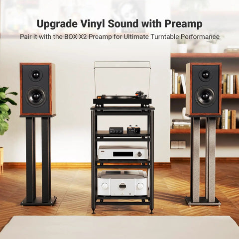 Turntable setup with speakers on stands, black audio rack with amplifier, room setting
