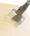 Close-up of Pro Grade Self Feed Drill Bit With Single Cutter For Woodworking Two And One Eighth Inch drilling into wood surface