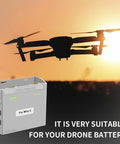 Dual Channel Battery Charger Hub For Mini 2 Series Drones Two Way Charge Station in front of flying Mini 2 drone at sunset