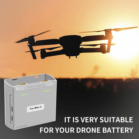 Dual Channel Battery Charger Hub For Mini 2 Series Drones Two Way Charge Station in front of flying Mini 2 drone at sunset