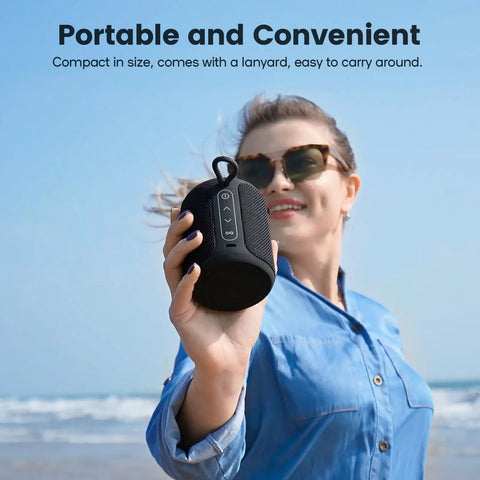Woman holding Rugged Waterproof Bluetooth Speaker With Lights, 15W Loud Stereo Sound, IP67 Dustproof Build at beach