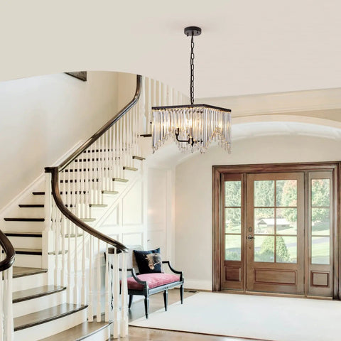Four Light Crystal Chandelier With Black Iron Frame And K9 Clear Crystals in elegant entryway with staircase and bench.