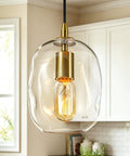 Pendant Lights Kitchen Island, Hand-Blown Clear Glass Brass Gold 9 Inch H, featuring a rounded glass shape and vintage bulb.