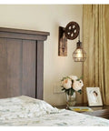 Vintage Black Rust Metal Sconces E27 Socket with pulley design mounted beside bed in cozy room setting.