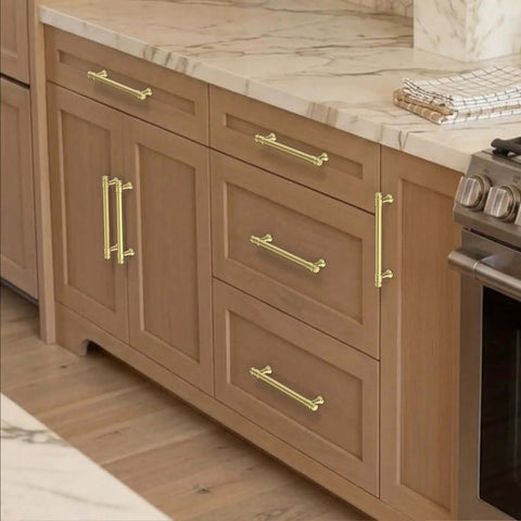 Brushed Gold Cabinet Pulls 5 Inch Zinc Alloy Handles Set of 10 on wooden kitchen cabinets and drawers, side view