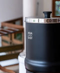2.25 Gallon Gravity Water Filter System With Dual Activated Carbon Filters in matte finish, side view indoors