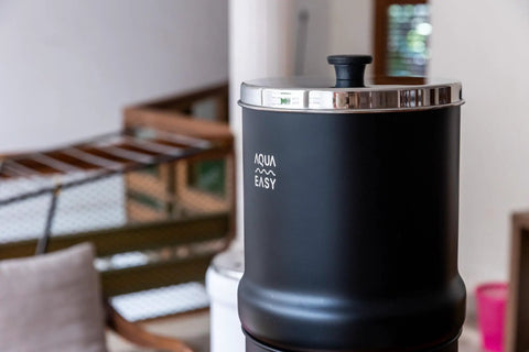2.25 Gallon Gravity Water Filter System With Dual Activated Carbon Filters in matte finish, side view indoors