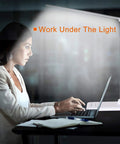 Woman using laptop under Eye Caring LED Desk Lamp With USB Charging Port, Touch Dimmable Office Light, Memory And Timer, white color.
