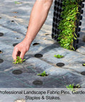 Person installing Heavy Duty Garden Stakes And Ground Anchors U Shape Steel Nails For Artificial Grass Sod Weed Membrane And Grass Fabric Netting 15 Pack Built To Last Rust Resistant And Bend Proof into landscape fabric