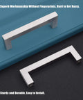 Two stainless steel cabinet handles on blue surface, showcasing superb workmanship and easy installation.