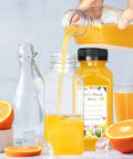 Pouring juice into 30 Pack 8oz Clear Plastic Bottles With Leak Proof Caps For Juices Smoothies Milk And Other Drinks Food Grade PET Recyclable Bulk Containers Perfect For Homemade Beverages
