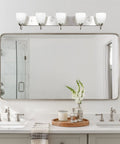 Armada 36 Inch Five Light Modern Vanity Light with brushed nickel finish and frosted glass shades above bathroom mirror.
