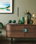Living room with wood cabinet featuring 2 Pack Teal Blue And Gold Fluid Art Cabinet Pulls With 3 Inch Center Hole, decor items on top.