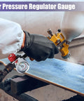 Person using One Quarter Inch Air Regulator With Gauge 0-140 Psi for Spray Guns and Paint Sprayers on a wooden surface