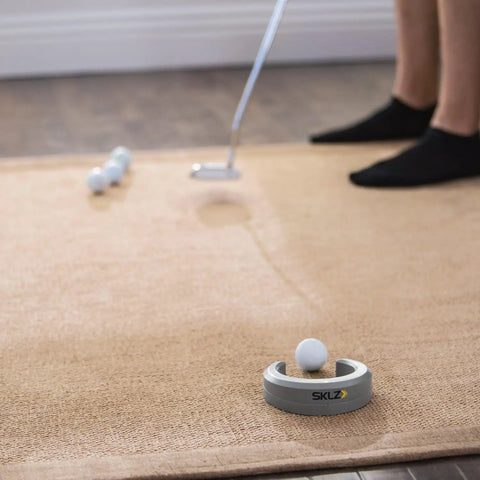 Golf Putting Cup Accuracy Trainer in Horseshoe Shape for Home and Office Practice on a carpet with golf balls and putter