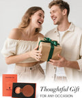 Couple holding gift box and showcasing Magnetic Hat Clip For Travel On Bag Made From Genuine Leather With Strong N52 Magnet