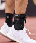 Person wearing 849 Ultra Gel Lace Up Ankle Support With Internal Gel Cushions For All Day Comfort Pre Curved Tongue Large Black